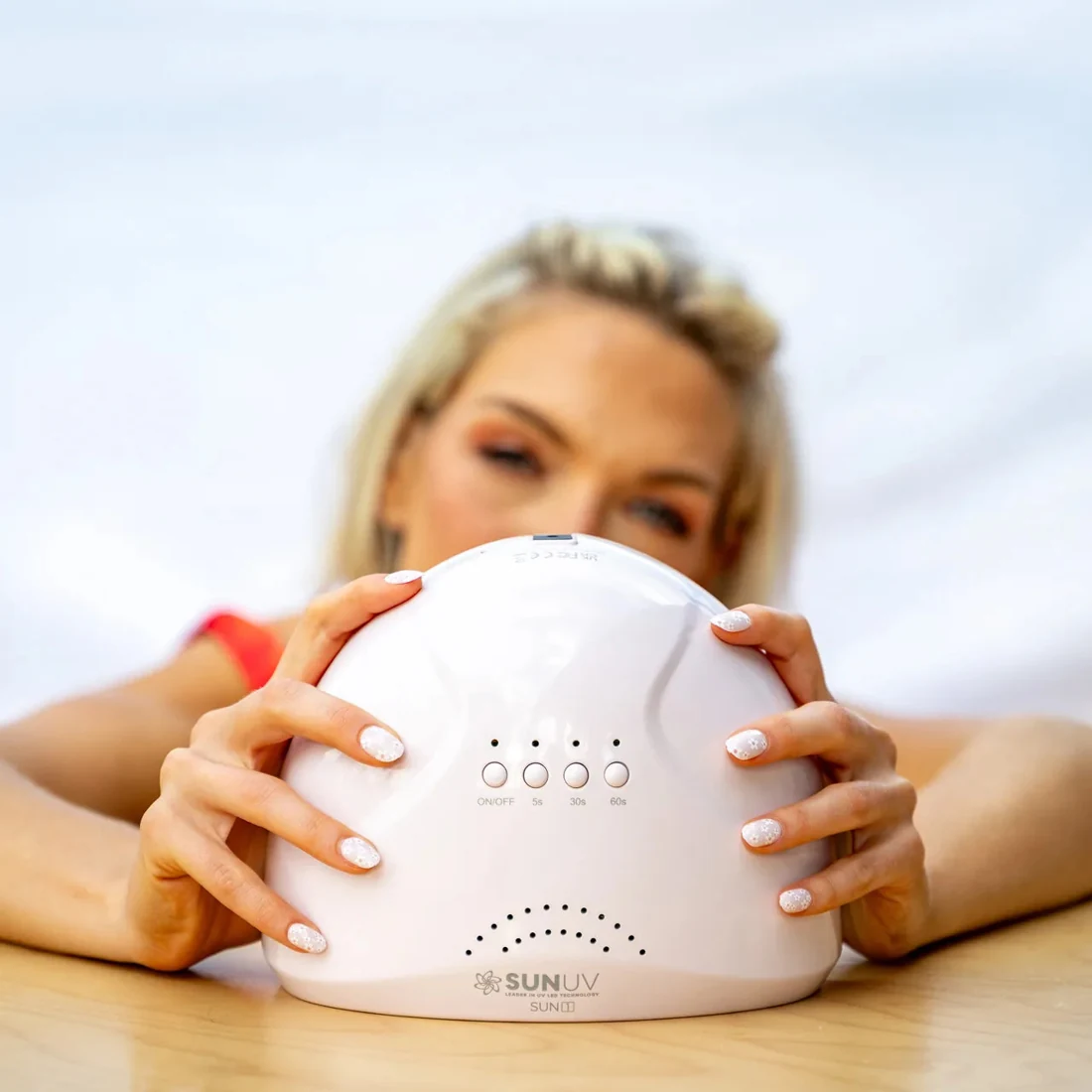 A gel manicure enthusiast holding a SUNUV SUNONE lamp